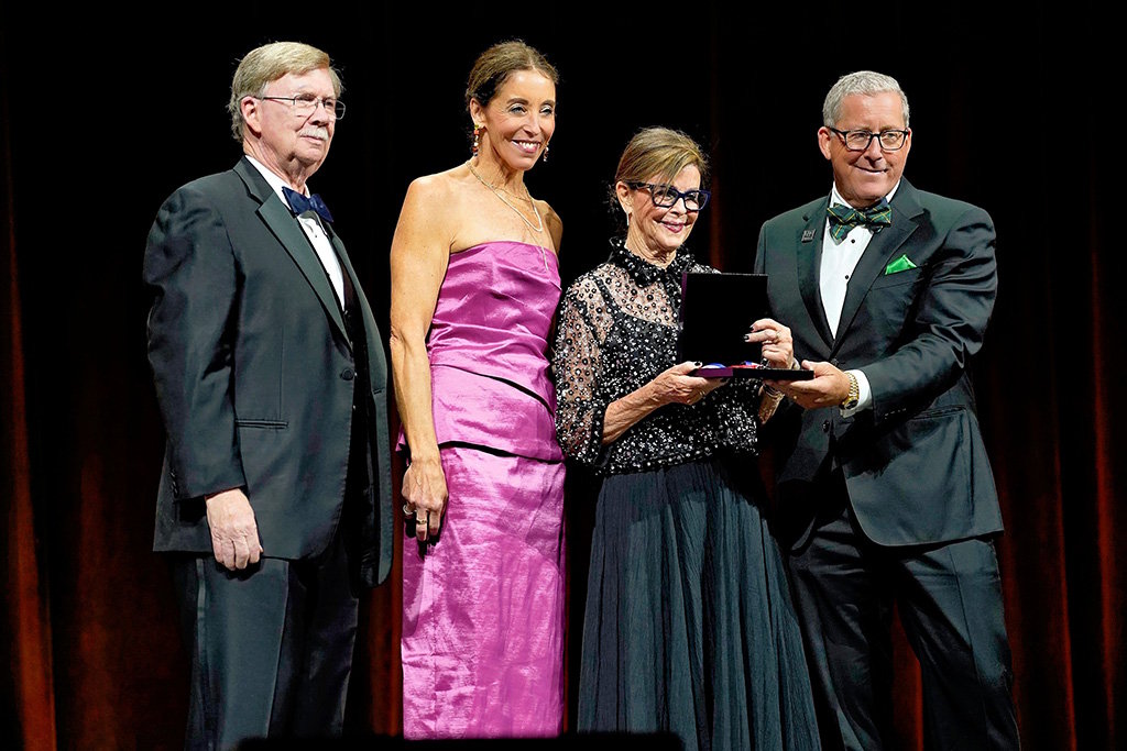 John Barry presents the National Aviation Hall of Fame award to members of John Odegard's family