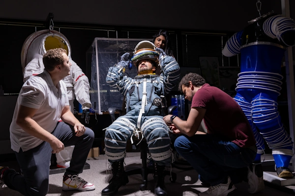 Researcher suiting up in space suit