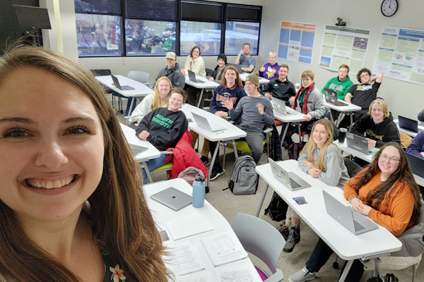 A professor takes a selfie with her class