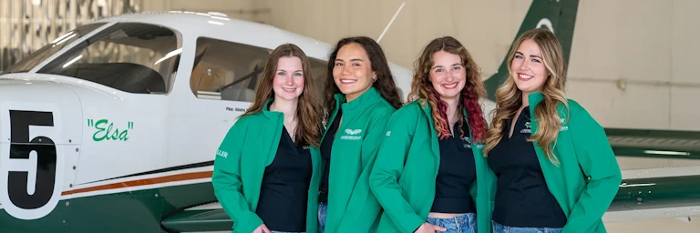The UND Frozen Force Air Race Classic team pose in front of their aircraft