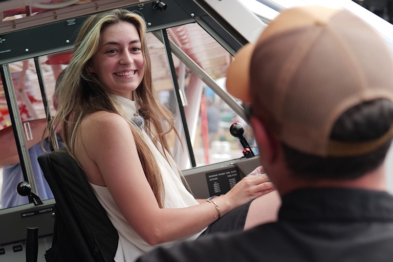 Ashley Almquist sits in the cockpit of her new Aviat Husky A-1C