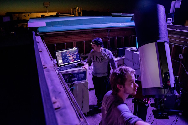 Two people run the UND Observatory at night